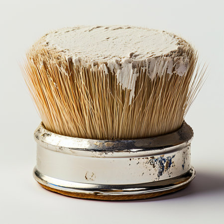 Paint brush with white paint on a white background, close upの素材