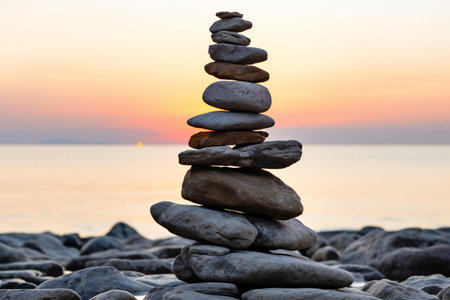 Pyramid of stones on the seashore at sunset. Zen conceptの素材