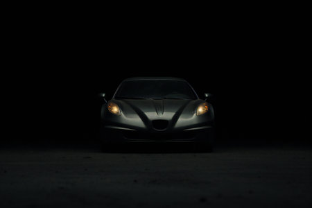 Close-up of a sports car on the road at night.の素材