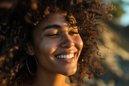 Close up portrait of a beautiful young african american woman smiling outdoorsの素材