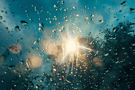 Water drops on the car glass with sun rays and bokeh backgroundの素材