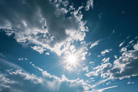 Blue sky background with white clouds and bright sun. Nature composition.の素材
