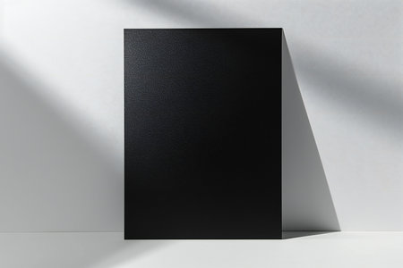 Black paper sheet on white background. Mock up,の素材