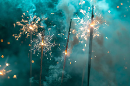 Beautiful sparklers on the background of the night sky. New Year's Eve.の素材