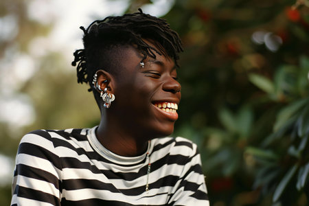 Portrait of a young african woman smiling in the park.の素材