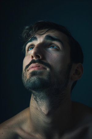 Portrait of a handsome young man with a beard on a dark backgroundの素材