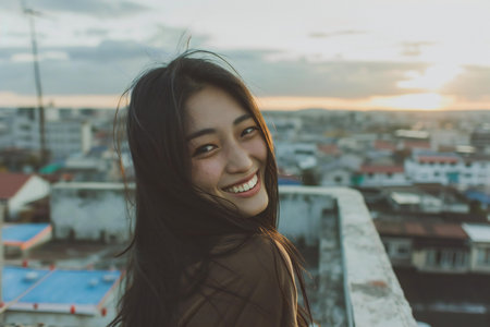 Beautiful asian woman smile and look at the camera with sunset.の素材