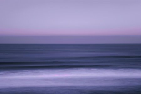 Seascape with motion blur effect. Long exposure photo of the sea at sunset.の素材