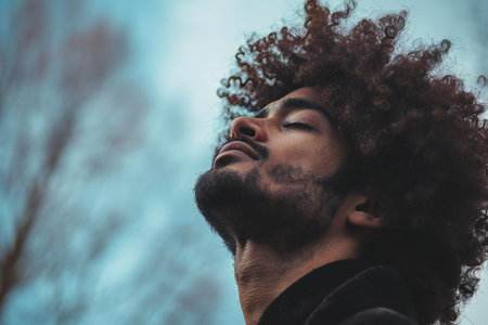 Portrait of a handsome young man with afro curly hair.の素材
