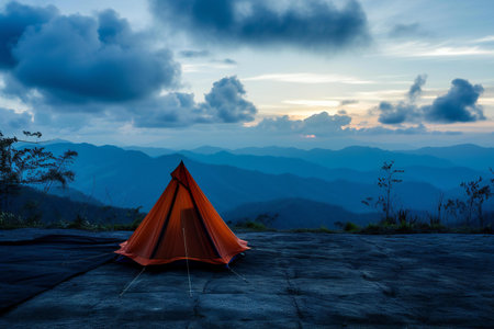 Camping orange tent on the mountain at sunset time, Thailand.の素材