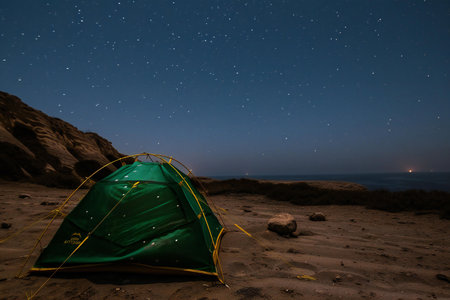 Camping on the beach at night with starry sky and starsの素材