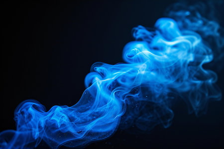 Blue smoke isolated on black background. Abstract background. Design element.の素材
