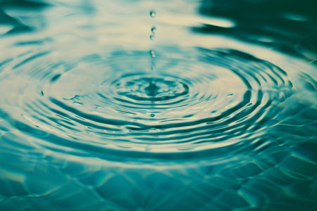 Water drop with ripples and waves. Abstract background for design.の素材