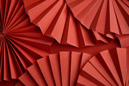 Red paper fan background. Red origami paper fan pattern texture.の素材