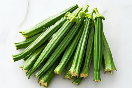 Fresh okra on white marble table, top view, copy spaceの素材