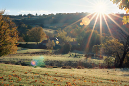 Autumn rural landscape with the sun in the clouds and the villageの素材