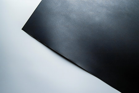 Black paper texture background. Black paper sheet on a white background.の素材