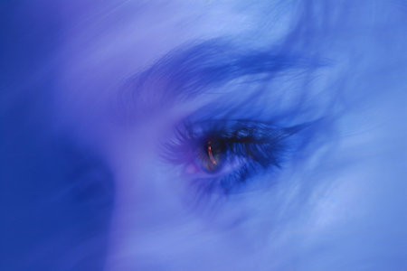 Close up of an eye in a blue light. Intentional motion blurの素材