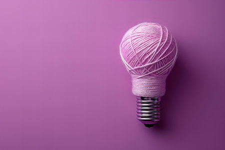Light bulb and ball of yarn on color background, creative idea concept