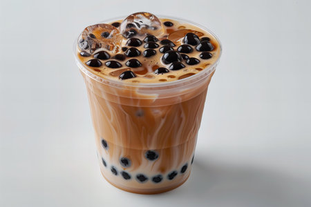 Iced Thai Milk Tea with Bubbles in Plastic Cup on White Backgroundの写真素材
