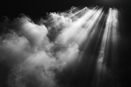 Abstract black and white clouds with sunbeams and lens flare.