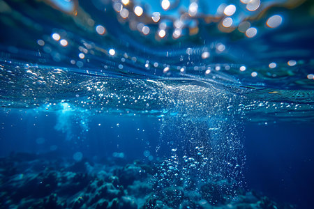 Underwater view of the coral reef and blue water with sunbeams