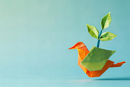 Paper origami bird and plant on a blue background.の写真素材