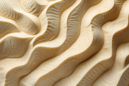 close up of the texture of beige butter cream on a white background