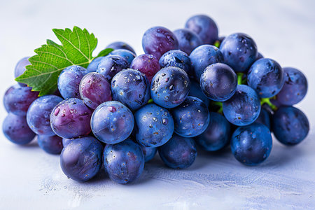 Fresh grapes with leaves on a white background. Selective focus.