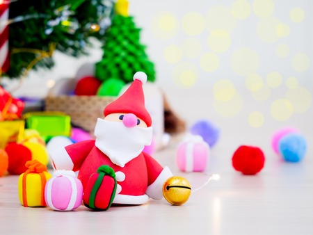 Pretty seanta among colorful christmas decoraitons. It is a giving season.の写真素材