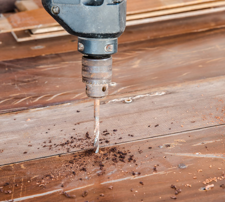 Electric hand drill drilling wood boardの写真素材