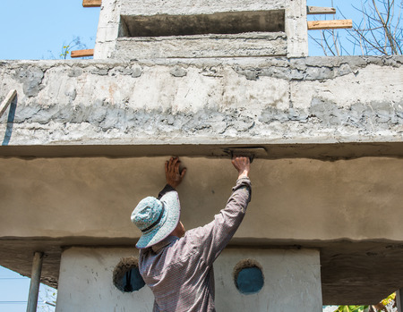 worker plasterize the ceiling and wall concreteの写真素材