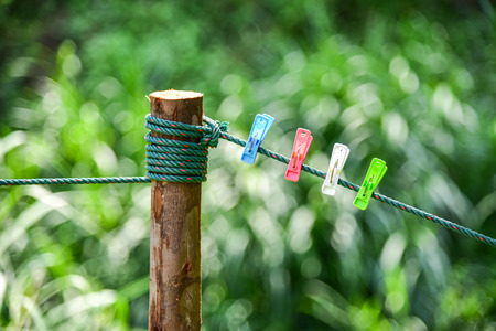 colorful of Clothespin clamp on rope with the green nature backgroundの写真素材