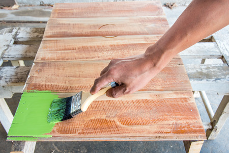 carpenter painting green color to wood boardの写真素材