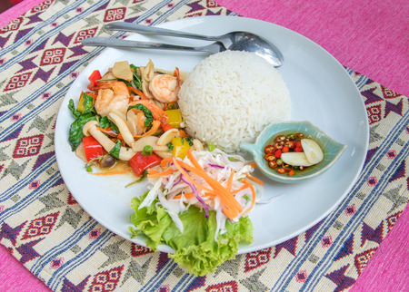 Stir-fried shrimp with holy basil and rice set serve with fish sauce mixed with red chili and lime . (Thai food name is \"PAD KRAPAO\" )の写真素材