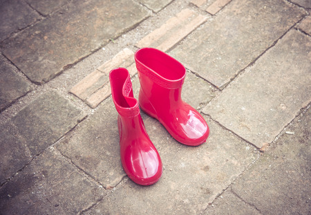 red color baby boots. garden boots for children , Vintage color toneの写真素材