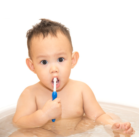 baby boy brushing teeth by blue color tooth brushの写真素材