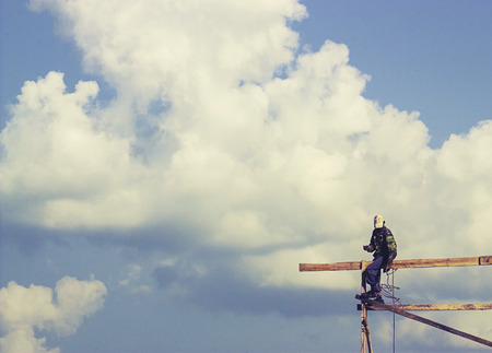 carpenter on the top of roof structure when building wooden house in THAILANDの写真素材