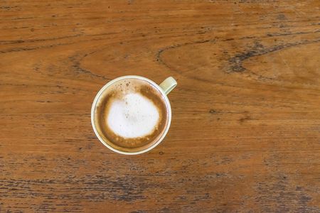 Beautiful latte Coffee cup on the wood tableの写真素材
