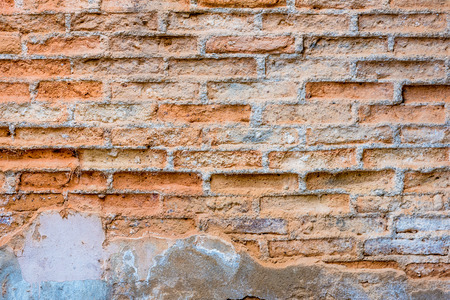 decayed old concrete wall  with red brickの写真素材