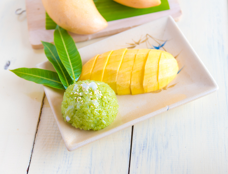 Thai style tropical dessert, sticky rice mixed coconut milk  with mangoの写真素材