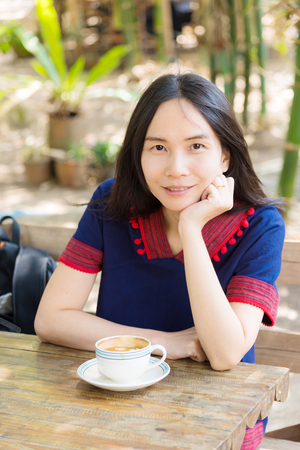 Thai lady in mountain people dress with coffee cupの写真素材