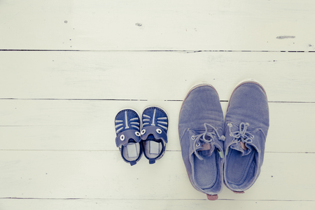 top view of father and baby shoe put togetherの写真素材
