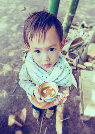 Thai  baby boy holding coffee cupの写真素材