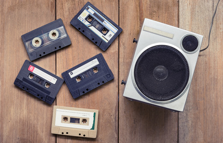 Top view Cassette tape and speaker laying on wood boardの写真素材