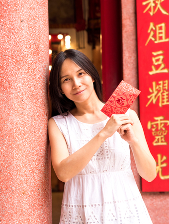 Asian lady holding red envelope or Ang-pow .の写真素材