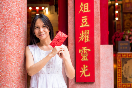 Asian lady holding red envelope or Ang-pow .の写真素材