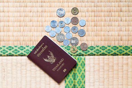 Thailand passport put together with Japanese coins and banknoteの写真素材