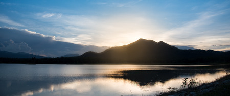 beautiful reflection of sky mountain and cloud on lake surface in evening timeの写真素材