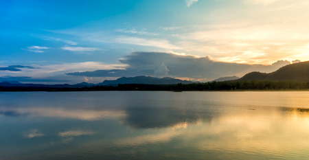beautiful reflection of sky mountain and cloud on lake surface in evening time